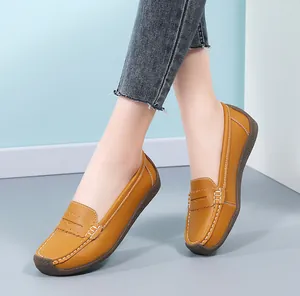 Detail view of yellow leather loafers with white stitching for comfortable daily wear