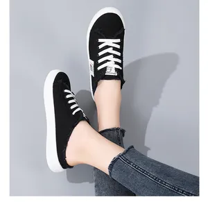 Minimalist black canvas backless sneakers for women with frayed edges and white laces