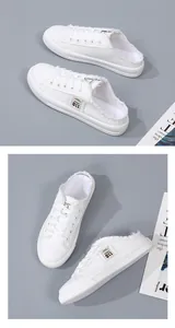 Close-up detail of stylish white canvas backless sneakers featuring frayed edges