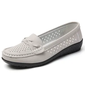 Comfortable grey women's loafers with perforated design and flat non-slip sole.
