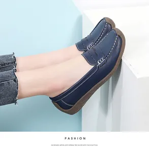 Side view of comfortable navy blue leather loafers for women with decorative white stitching