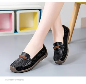 Detail van comfortabele zwarte leren loafers met opengewerkt patroon en zachte zool