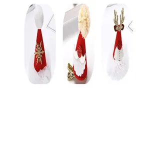 Detailed view of three festive Christmas hair clips: snowflake, Santa, and reindeer designs.