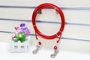 Macro view of a red steel wire pet tie-out cable with heavy-duty metal swivel hooks