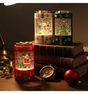 Detailed view of three glowing Christmas snow globe lanterns on vintage books