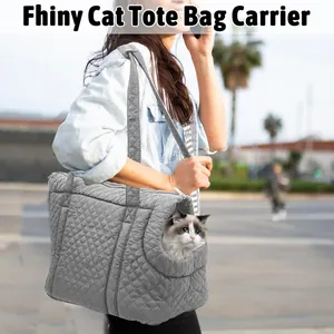 Grey quilted pet carrier tote bag shown being carried by a person outdoors