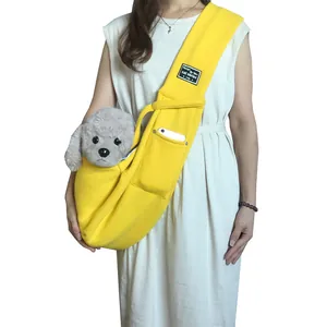 Bright yellow pet sling carrier for cats and small dogs with phone pocket.
