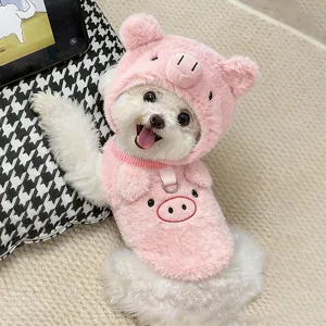Detailed view of a small white dog wearing a cute pink pig-themed plush pet hat and vest