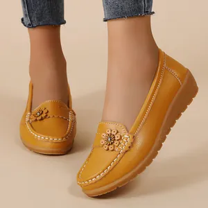 Comfortable yellow leather loafers with flower detail and white stitching for women