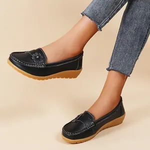 Stylish black women's loafers with floral accent and comfort wedge sole detail