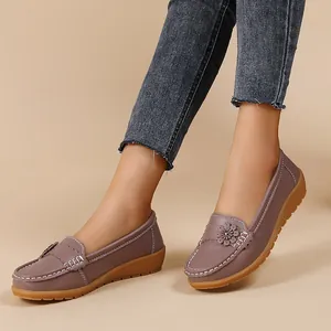Close-up of purple faux leather loafers with flower detail and contrast stitching
