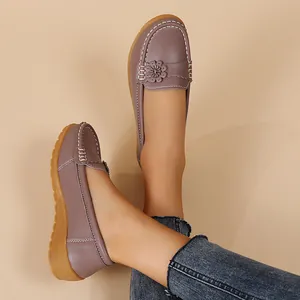 Detailed view of stylish lavender leather loafers for women featuring floral details