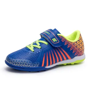 Kids low-top turf soccer shoes in blue and lime green for professional training