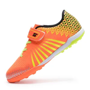 Youth orange low-top soccer shoes with TF turf cleats for professional training