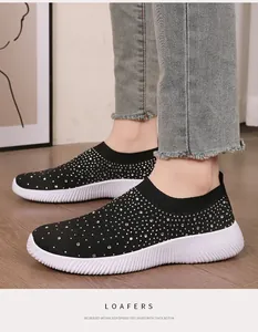 Close-up of black breathable rhinestone sock shoes with thick white soles on model
