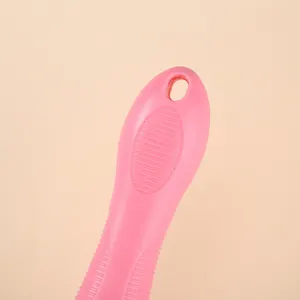 Detail of ergonomic pink pet grooming comb handle featuring a hanging hole for storage
