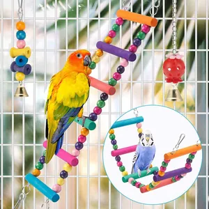 Colorful wooden climbing ladder and bell hanging toys for parrots in bird cage.