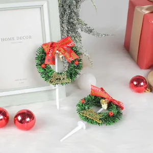 Festive mini Christmas wreath cake toppers with red bow and gold Merry Christmas signs