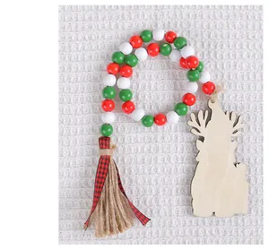 Detail of Christmas wooden bead garland with red green white beads and reindeer tag