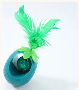 Detailed view of pineapple cat toy with green feather and internal ball