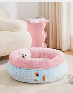 Gezellig roze en blauw geblokt huisdierbed met een kleine witte hond in huiselijke sfeer