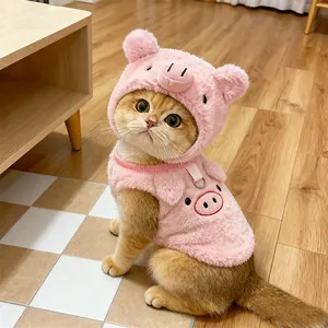 Close-up of a cute cat wearing a pink plush pig-themed transformation hat and vest
