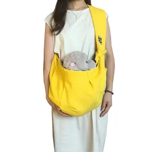 Adjustable soft yellow cotton pet carrier bag worn as a crossbody sling for small dogs