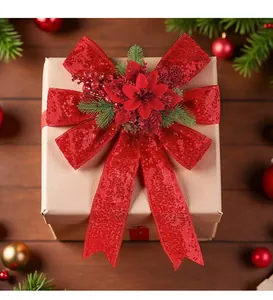 Red sequined Christmas bow with floral center decoration shown on a kraft gift box.