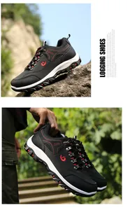 Professional black and red men's outdoor hiking shoes shown in a rugged natural landscape