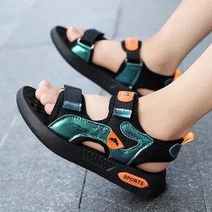 Comfortable boys' summer sports sandals with green metallic accents and orange velcro straps.