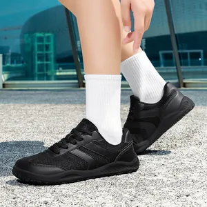 Retro black German Army Trainer style sneakers for men and women on outdoor ground