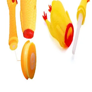 Detail view of disassembled screaming chicken dog toy showing internal components