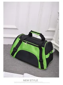Green and black breathable mesh pet carrier bag for cats and dogs on grey carpet