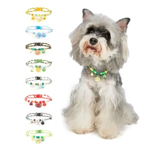 Variety of colorful cartoon pet collars with bells and charms displayed with a dog model view.