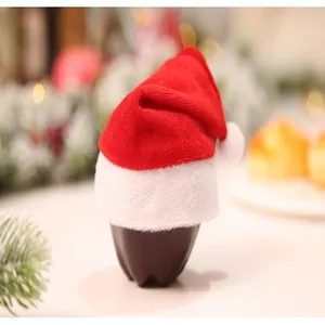 Close-up of mini red velvet Christmas hat with soft white plush trim and pom-pom