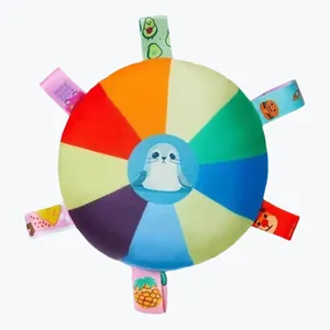 Detailed view of colorful plush pet frisbee toy with cartoon seal and fabric tags.