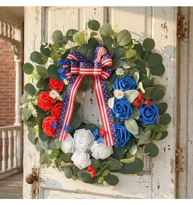 Close-up of Independence Day wreath with red white blue roses on rustic door