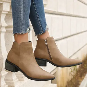 Side view of khaki pointy-toe ankle boots with a metal side zipper and block heel