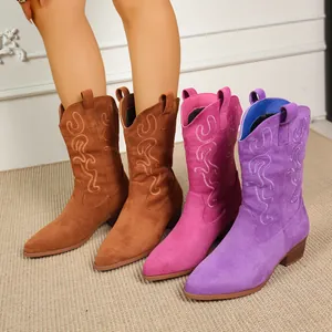 Detailed view of colorful embroidered suede western cowboy boots featuring retro pointed toes.
