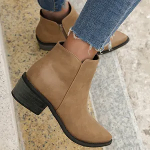 Close-up of stylish khaki pointed-toe ankle boots with chunky heel and side zipper.