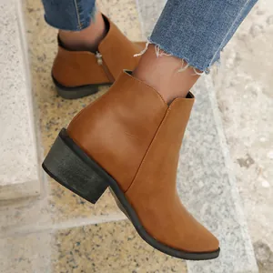 Detailed side view of brown pointed toe ankle boots with chunky heel and zipper.