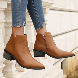 Side view of tan pointed-toe ankle boots with side zipper and chunky block heel