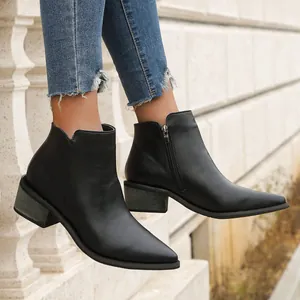 Side-view detail of women's pointed-toe black ankle boots with side zipper and block heel.