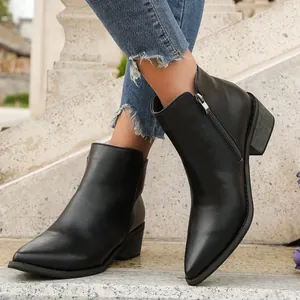 Detailed side view of stylish black pointed-toe ankle booties featuring a side zipper