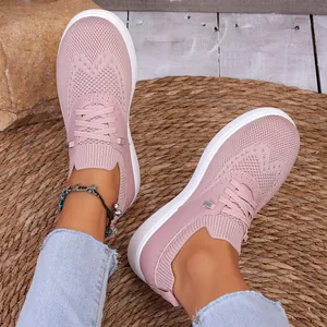 Gedetailleerde weergave van roze ademende flyknit loafers gedragen met jeans