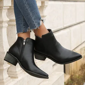Detail view of black pointed-toe ankle boots with side zipper and chunky heel