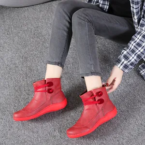 Close-up view of red British style women's high-top martin boots worn by a model