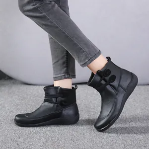 Close-up detail of black British style work leather Martin boots worn by a model