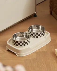 Close-up of double stainless steel pet feeding bowls with a black and white checkered design