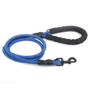 Detail view of blue reflective dog leash featuring a comfortable black padded foam handle